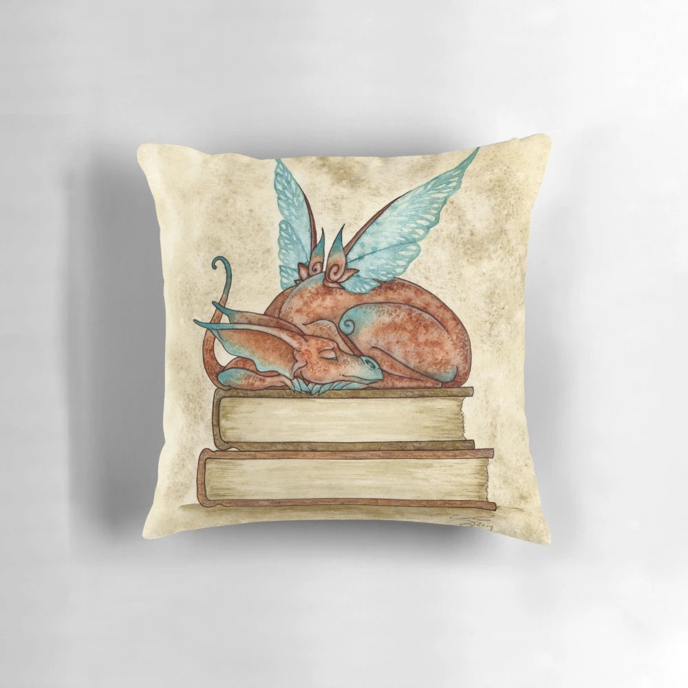 Whimsical fantasy-inspired pillow featuring dragons, fairies, and a magical book motif