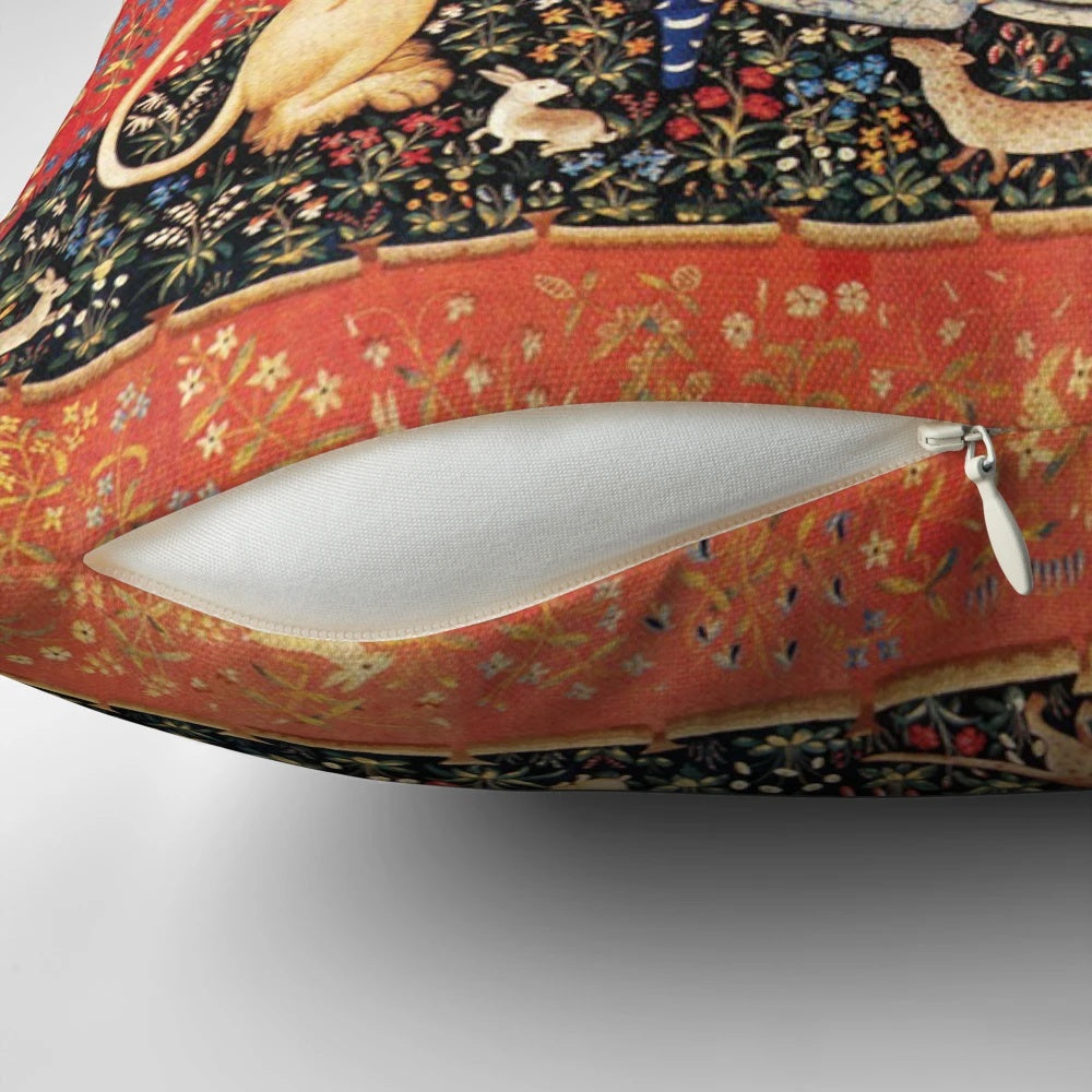 Decorative throw pillow featuring a fantasy unicorn surrounded by red, green, and blue flowers in a classic medieval art style