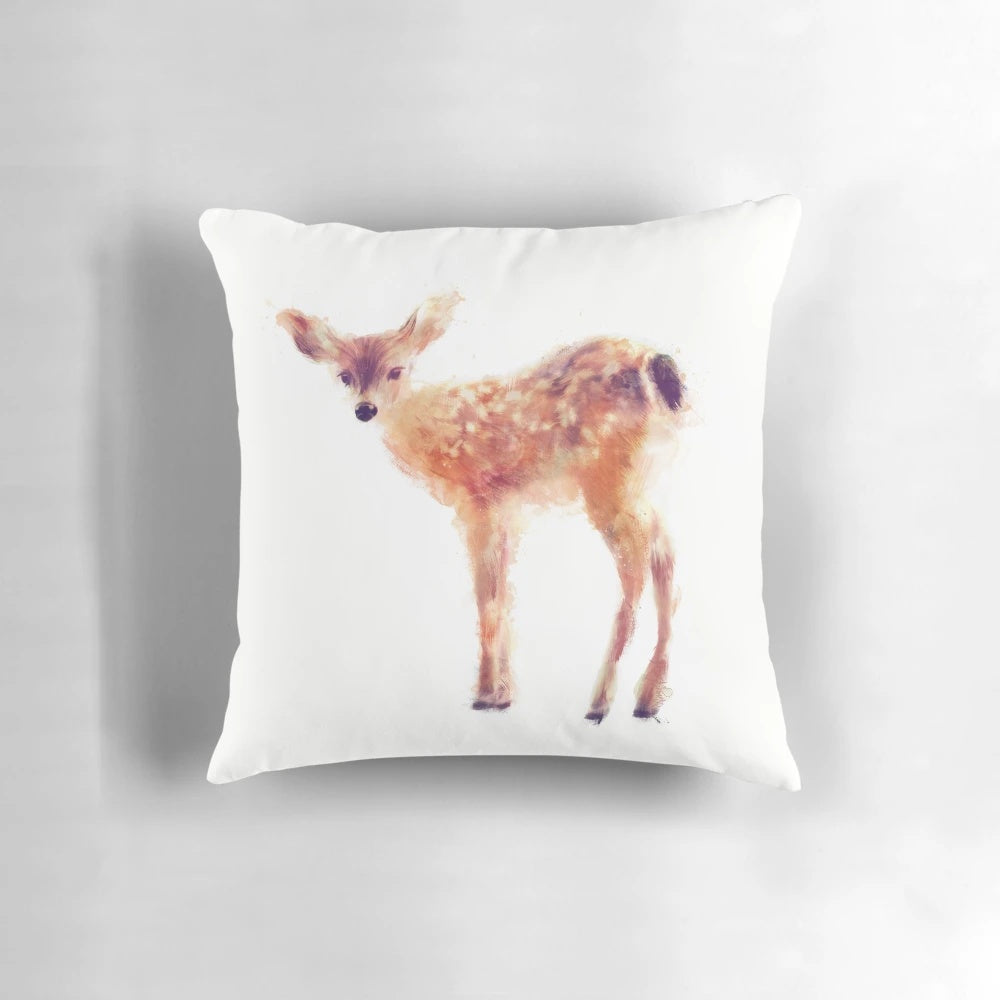 Soft, plush pillow featuring a charming fawn against a natural backdrop