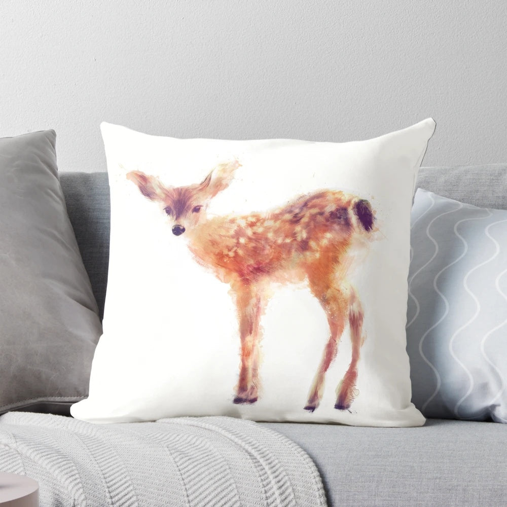 Soft, plush pillow featuring a charming fawn against a natural backdrop