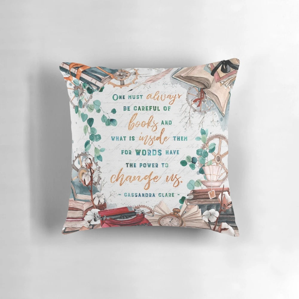 Decorative angel-themed throw pillow with a watercolor book stack and floral clockwork design, perfect for fantasy book lovers.