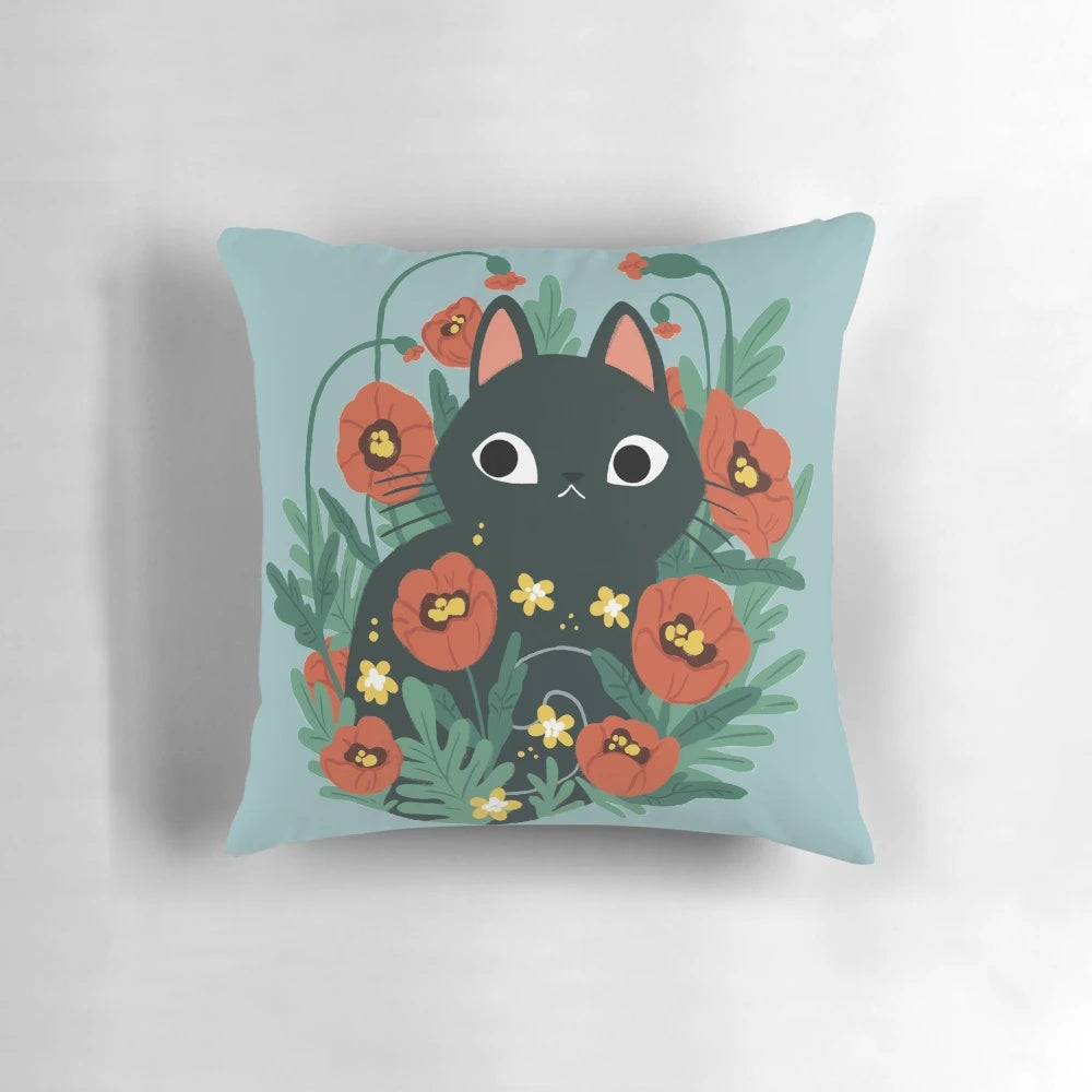 A cozy throw pillow featuring a charming black cat surrounded by vibrant poppy flowers and daisies.