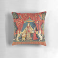 Decorative red and green floral tapestry pillow featuring a unicorn and lion in a medieval-inspired fantasy design.