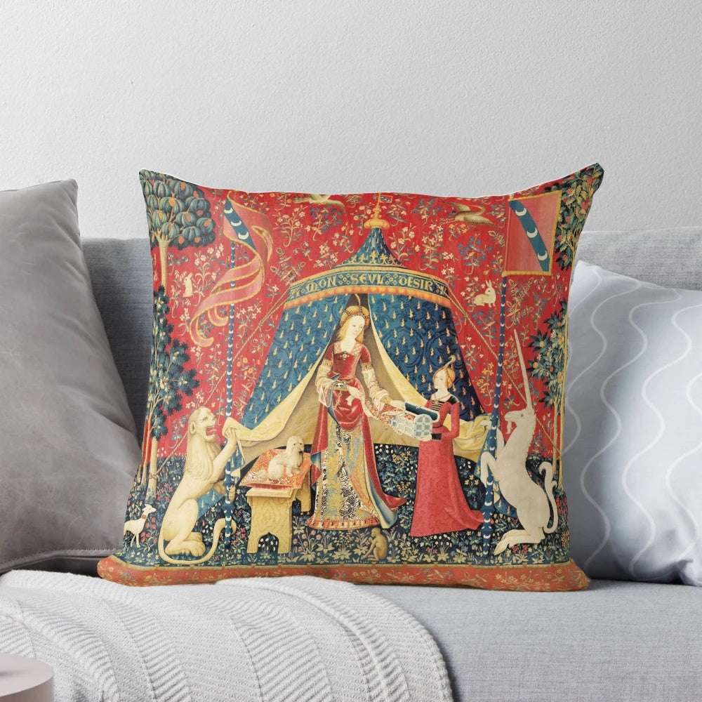 Decorative red and green floral tapestry pillow featuring a unicorn and lion in a medieval-inspired fantasy design.