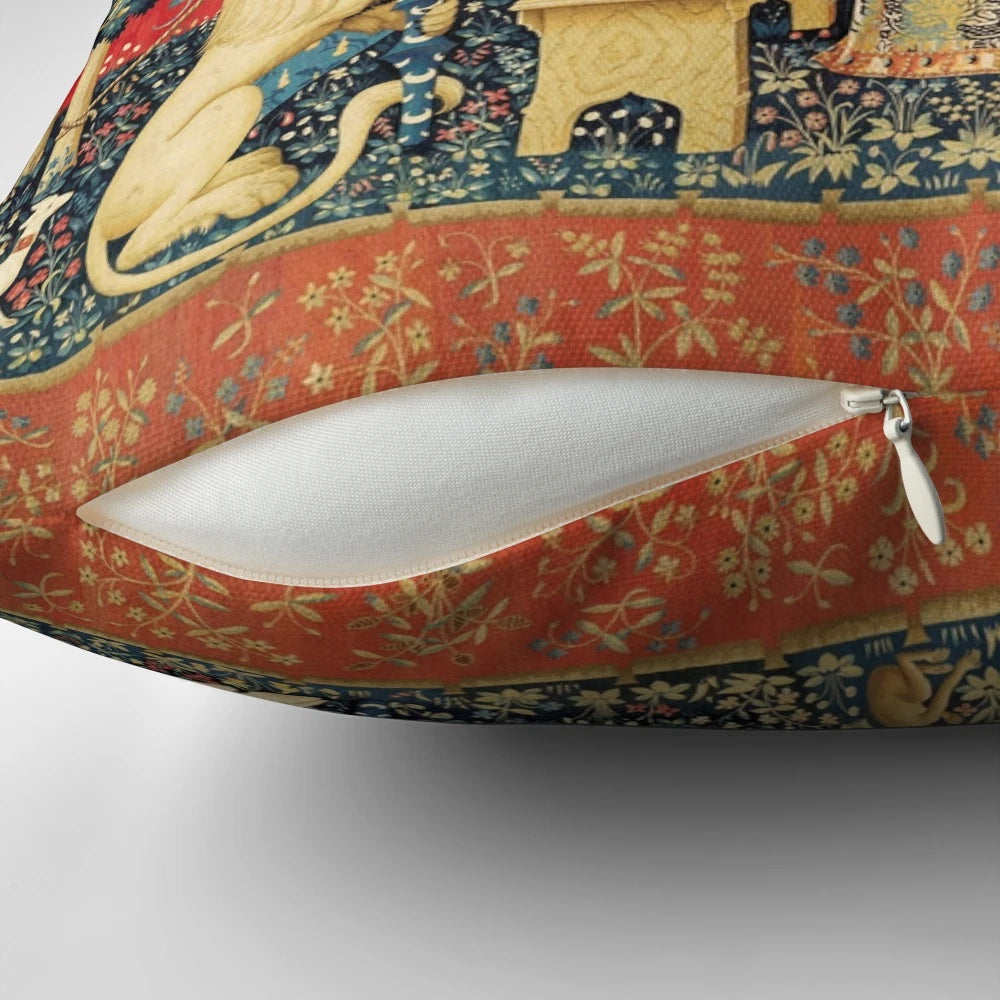 Decorative red and green floral tapestry pillow featuring a unicorn and lion in a medieval-inspired fantasy design.