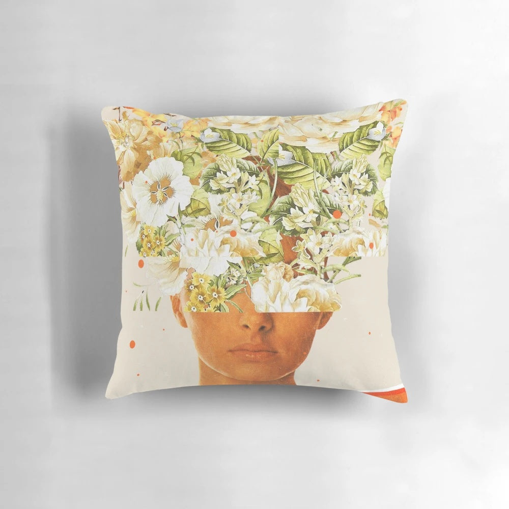 A vibrant, surreal pillow featuring a woman's face adorned with a colorful flower crown design.