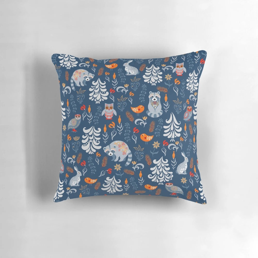Decorative pillow featuring a whimsical pattern of forest animals like raccoons, owls, bunnies, and a chick in an autumnal woodland setting.