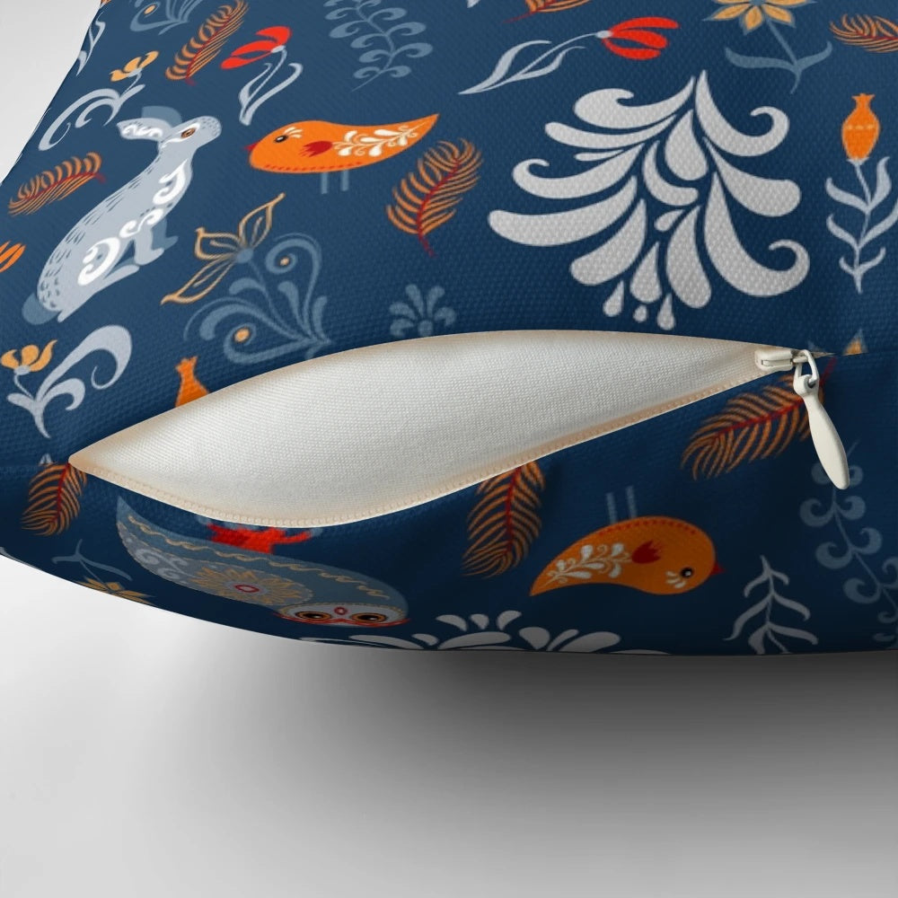 Decorative pillow featuring a whimsical pattern of forest animals like raccoons, owls, bunnies, and a chick in an autumnal woodland setting.