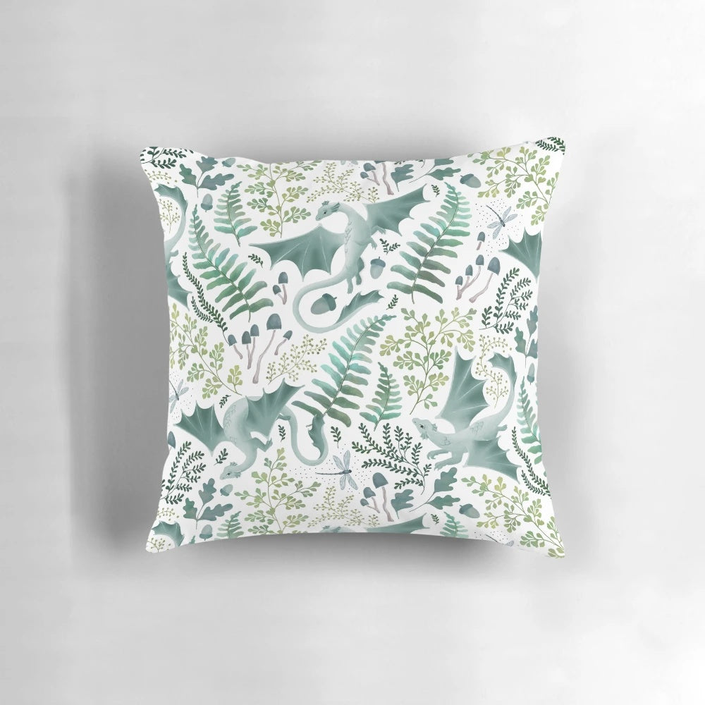 Vibrant green forest dragons printed on a white decorative pillow