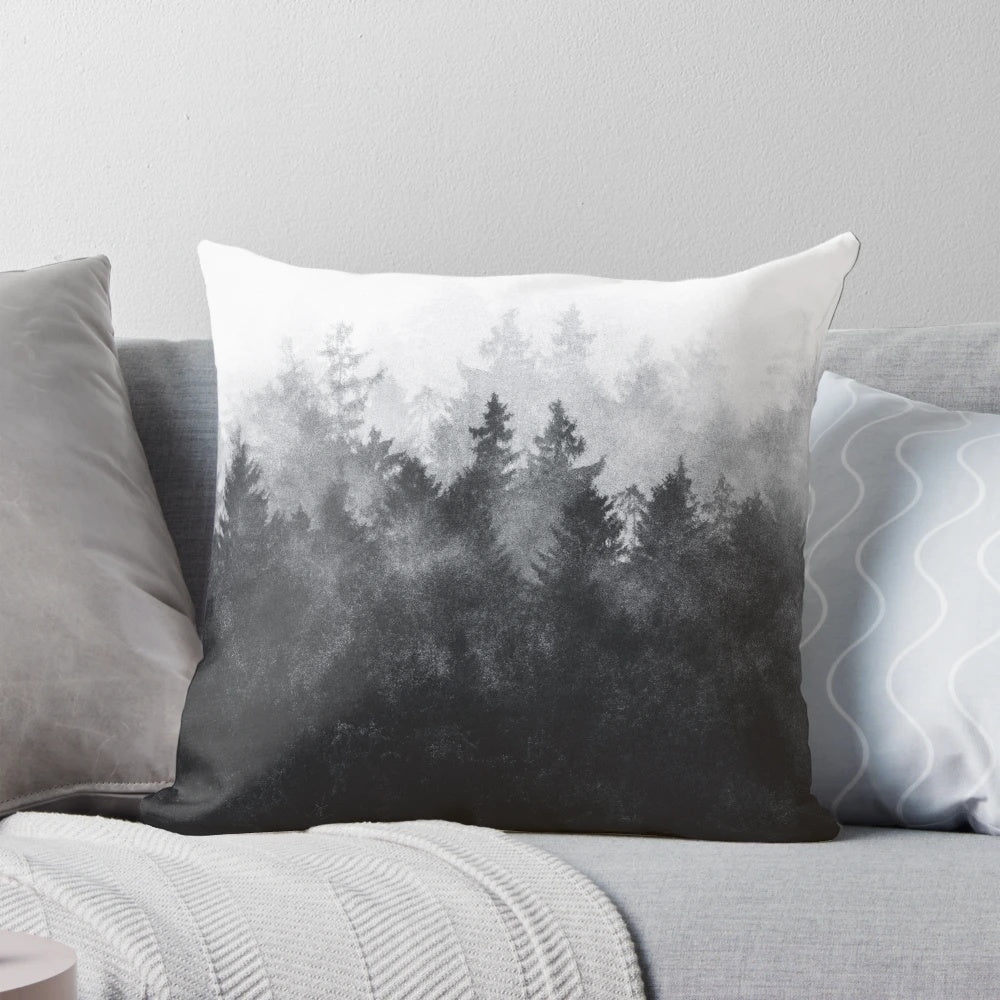 Pillow featuring a watercolor painting of a misty, foggy forest with trees and mountains.