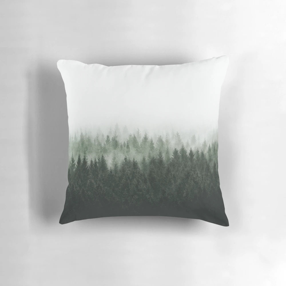 A cozy forest pillow featuring Cascadia trees covered in magical light and misty fog, creating a fairytale-like wilderness scene.