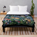 Enchanted forest plush blanket featuring wildlife and botanical designs