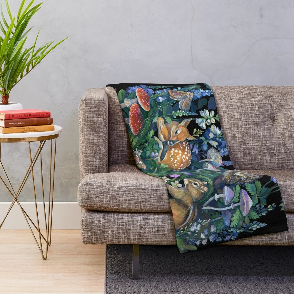 Enchanted forest plush blanket featuring wildlife and botanical designs