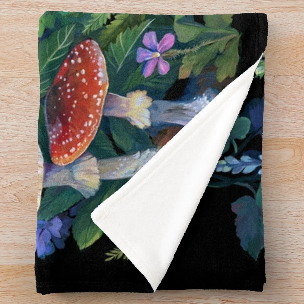 Enchanted forest plush blanket featuring wildlife and botanical designs