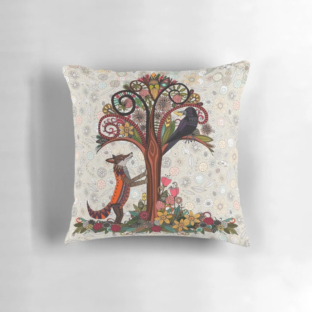 Colorful pillow featuring a fox and crow surrounded by floral and woodland elements