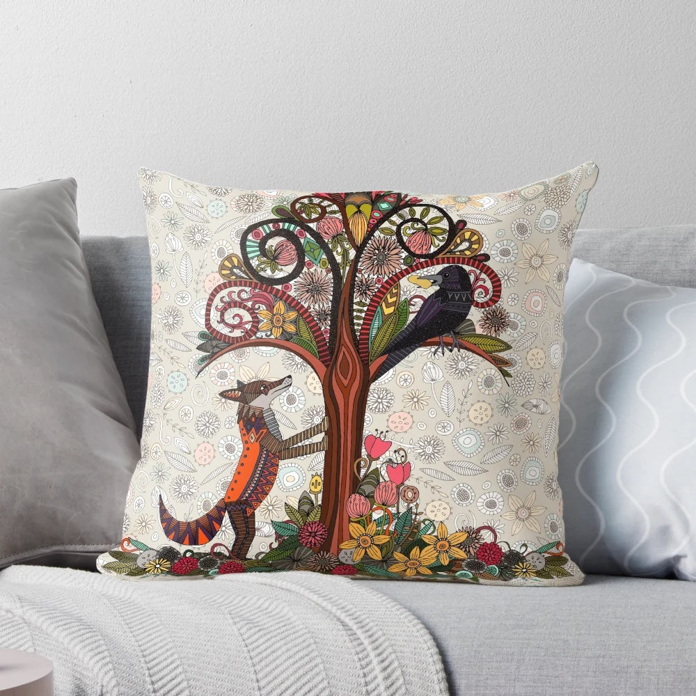 Colorful pillow featuring a fox and crow surrounded by floral and woodland elements