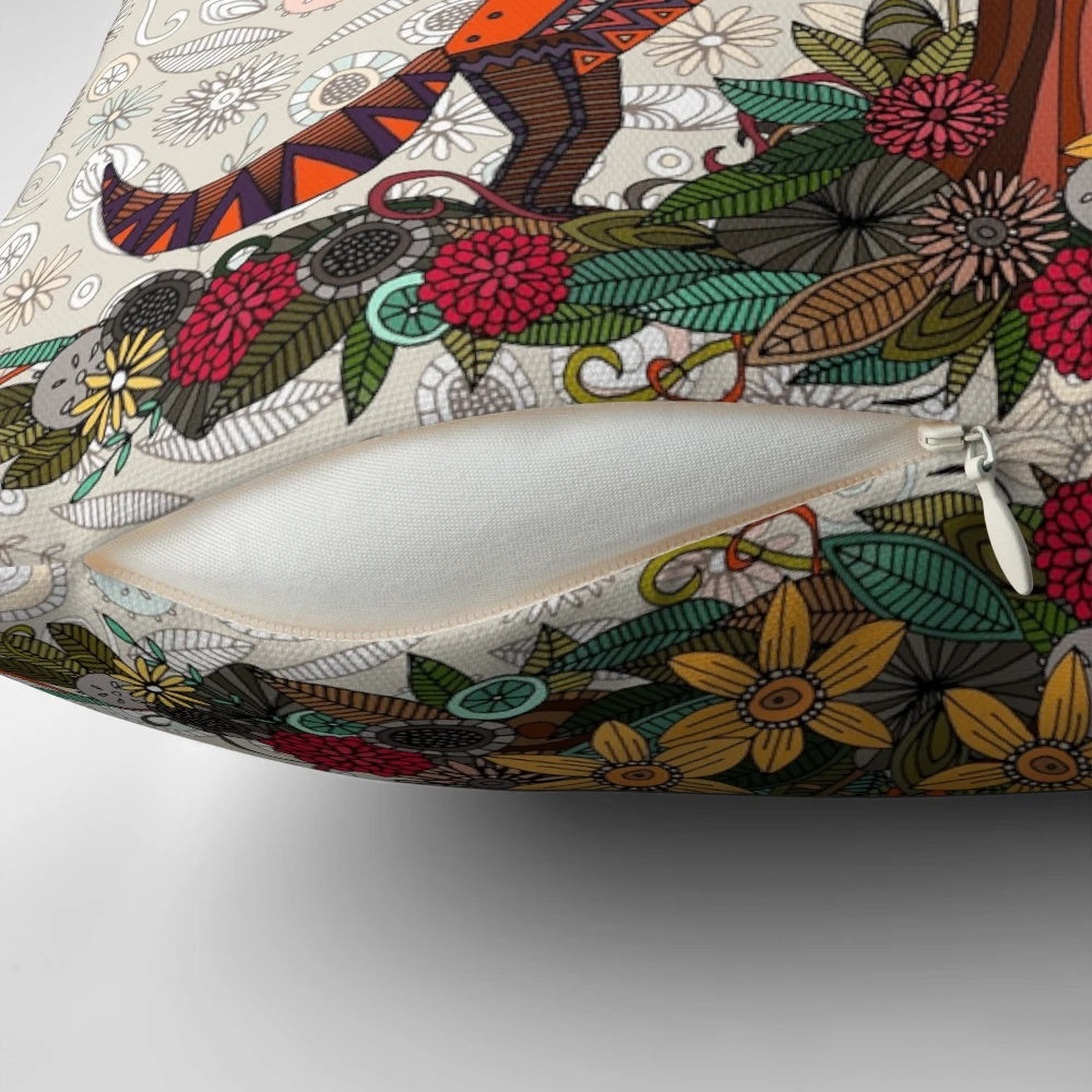 Colorful pillow featuring a fox and crow surrounded by floral and woodland elements