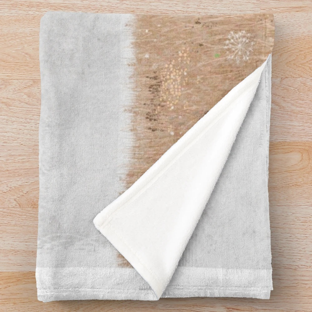 Soft and cozy plush blanket featuring a ghostly meadow scene with wildflowers