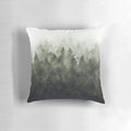 A cozy pillow featuring a dreamy, moody forest landscape with trees covered in magical fog, evoking a sense of tranquility and adventure.