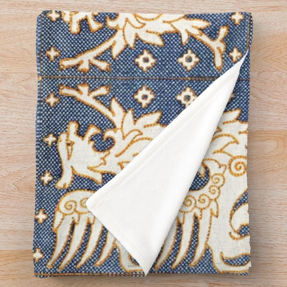 Plush blanket featuring a design of gold white gryphons on a blue background