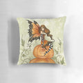 Whimsical orange and black pillow with a fairy and pumpkins, perfect for Halloween and fall home decor.