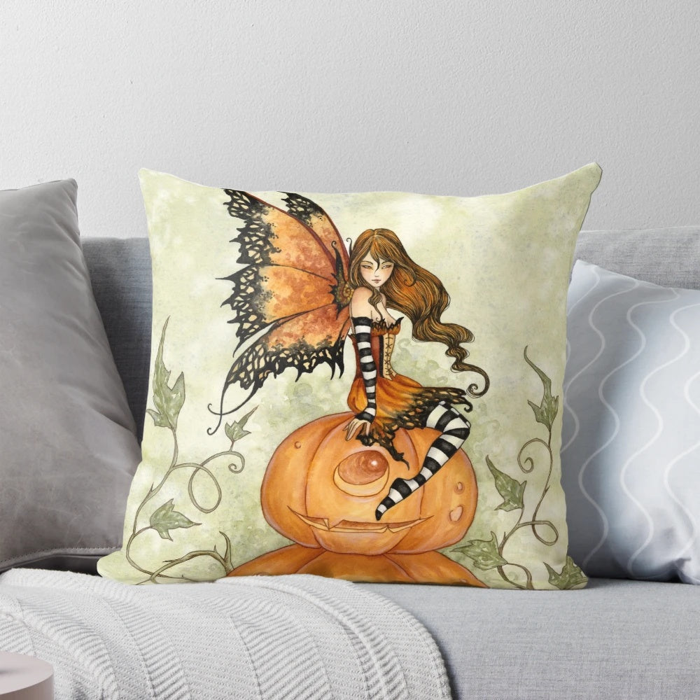 Whimsical orange and black pillow with a fairy and pumpkins, perfect for Halloween and fall home decor.