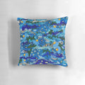 Vibrant hand-painted flowers floating on a blue background, creating a serene and captivating pillow design.