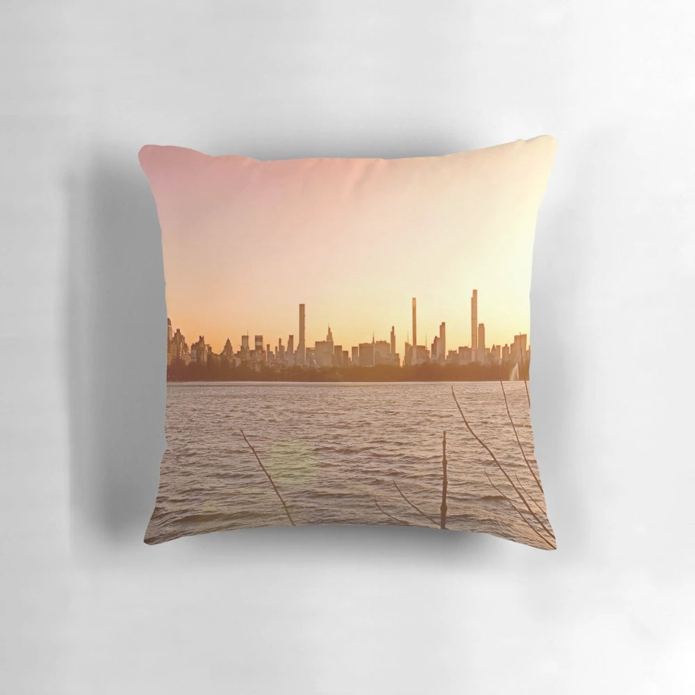 Jacqueline Kennedy Onassis Reservoir Pillow showcasing the stunning New York City skyline at sunset