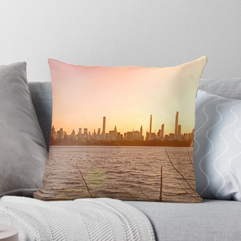 Jacqueline Kennedy Onassis Reservoir Pillow showcasing the stunning New York City skyline at sunset