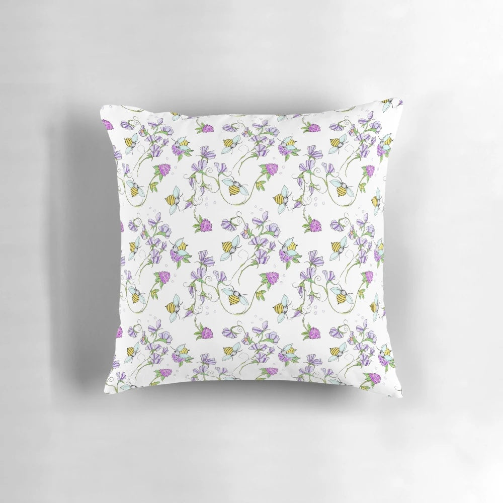 Vibrant floral pillow featuring sweet peas and bees in a whimsical, nature-inspired design
