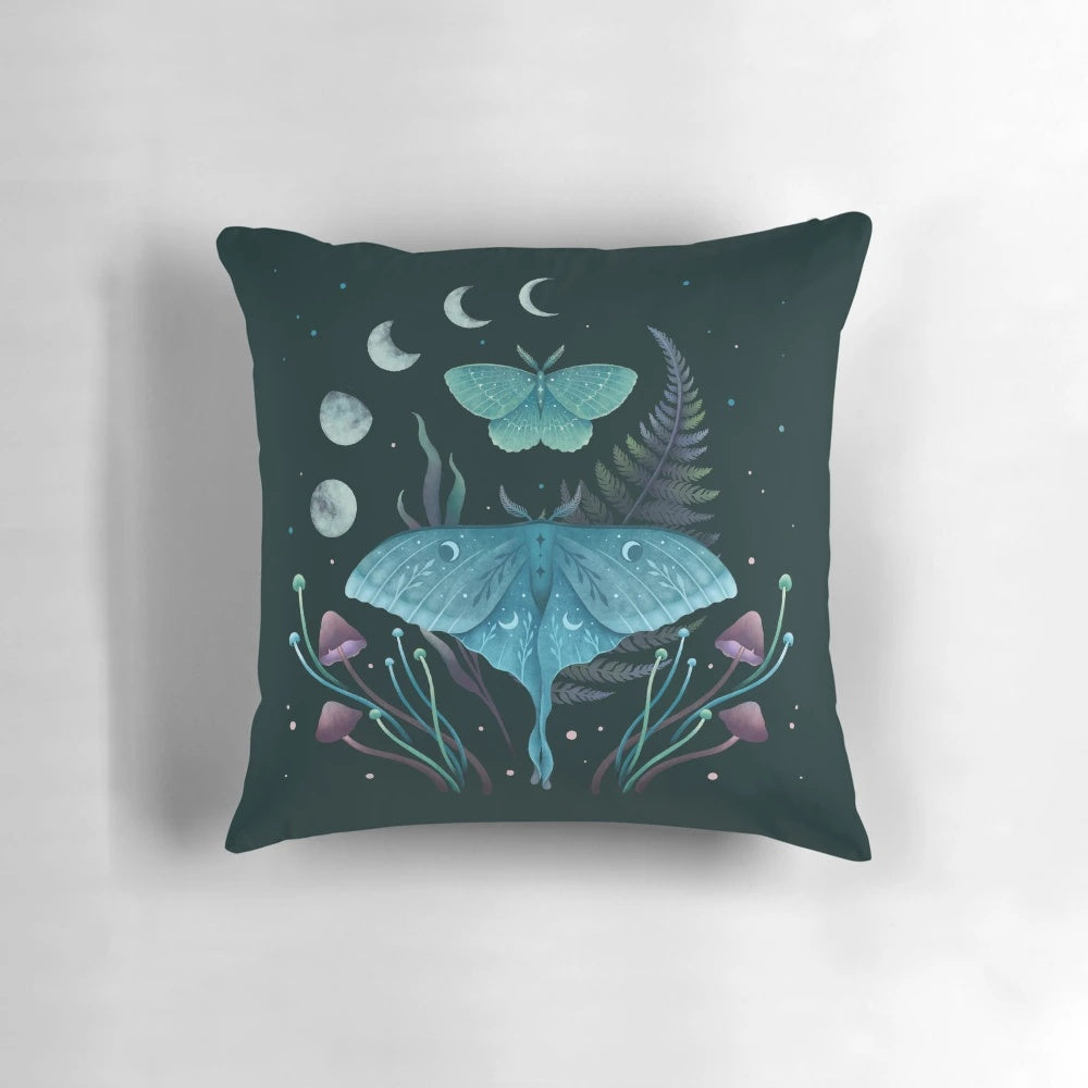 Pillow featuring illustrations of the luna moth and emerald moth in a moonlit garden