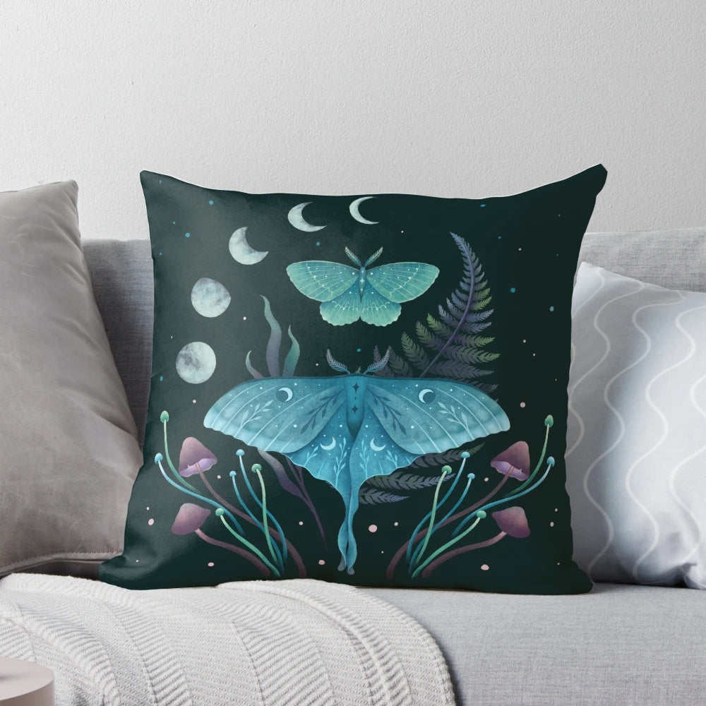 Pillow featuring illustrations of the luna moth and emerald moth in a moonlit garden
