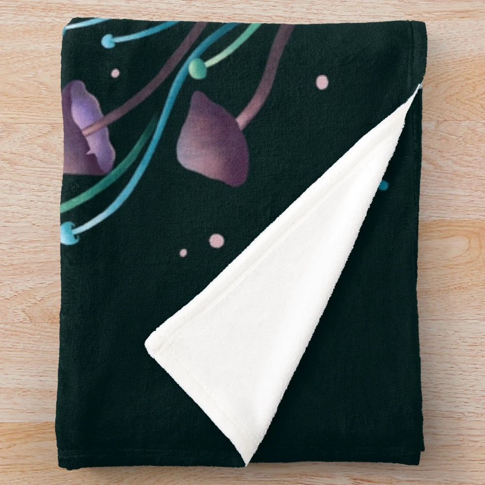 Plush blanket featuring a luna moth and emerald moth design in a botanical, night garden scene