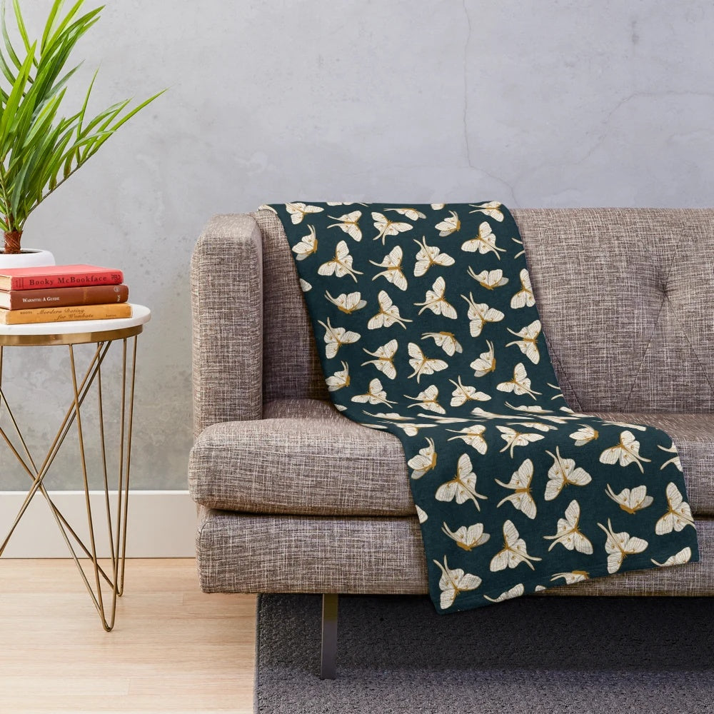 Luna moth plush blanket in gold and dark teal colors