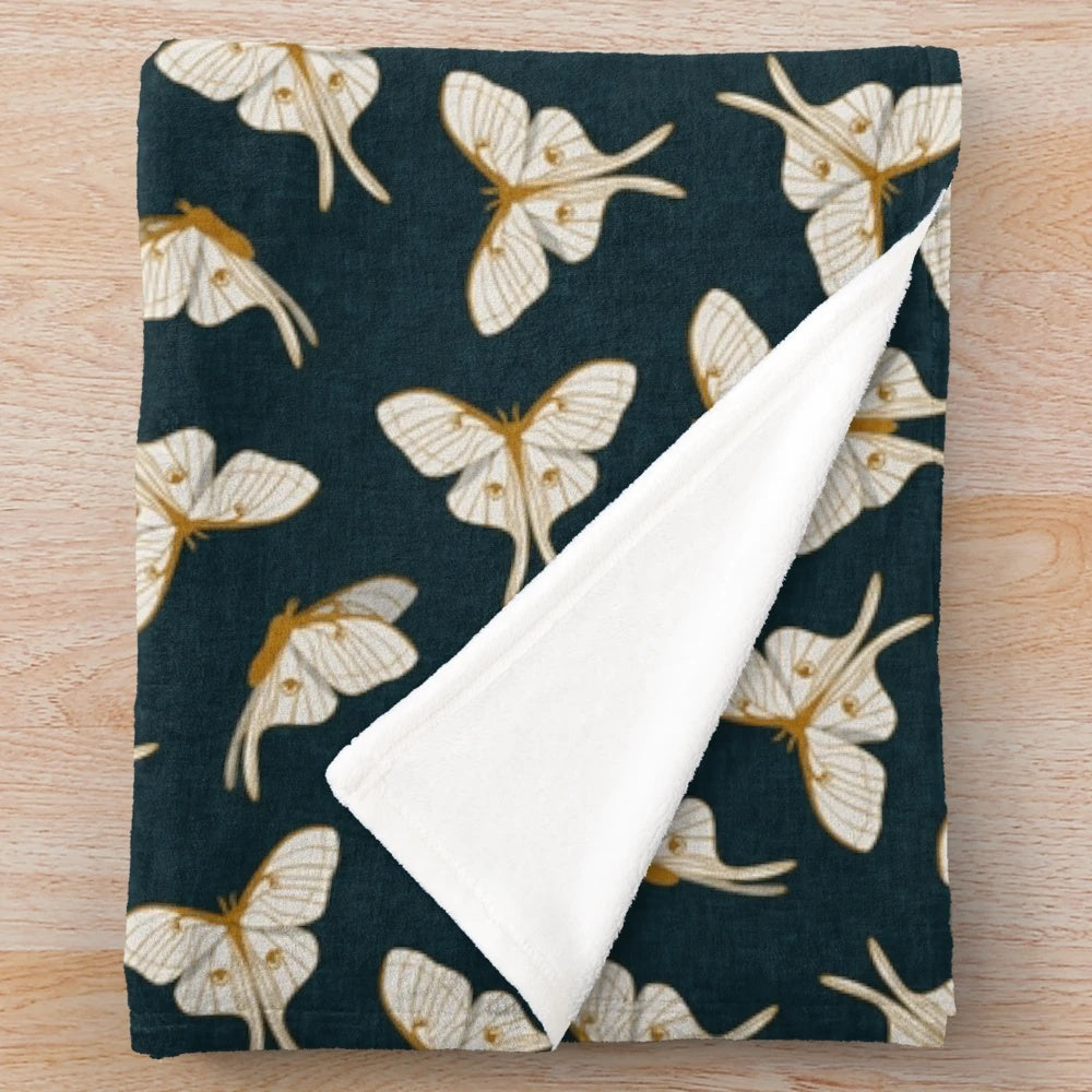Luna moth plush blanket in gold and dark teal colors