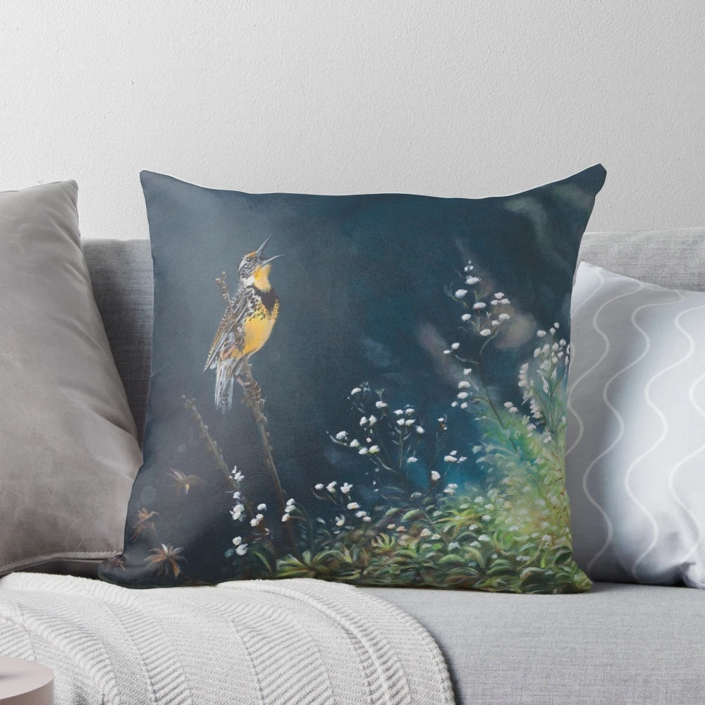 A whimsical pillow featuring a painted meadowlark songbird in a lush, floral meadow setting