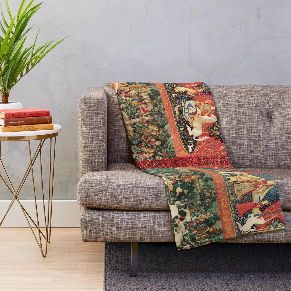 Plush blanket featuring a medieval-style illustration of a unicorn and ladies in a fantasy floral garden