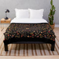 Medieval-inspired floral pattern on a soft, black plush blanket