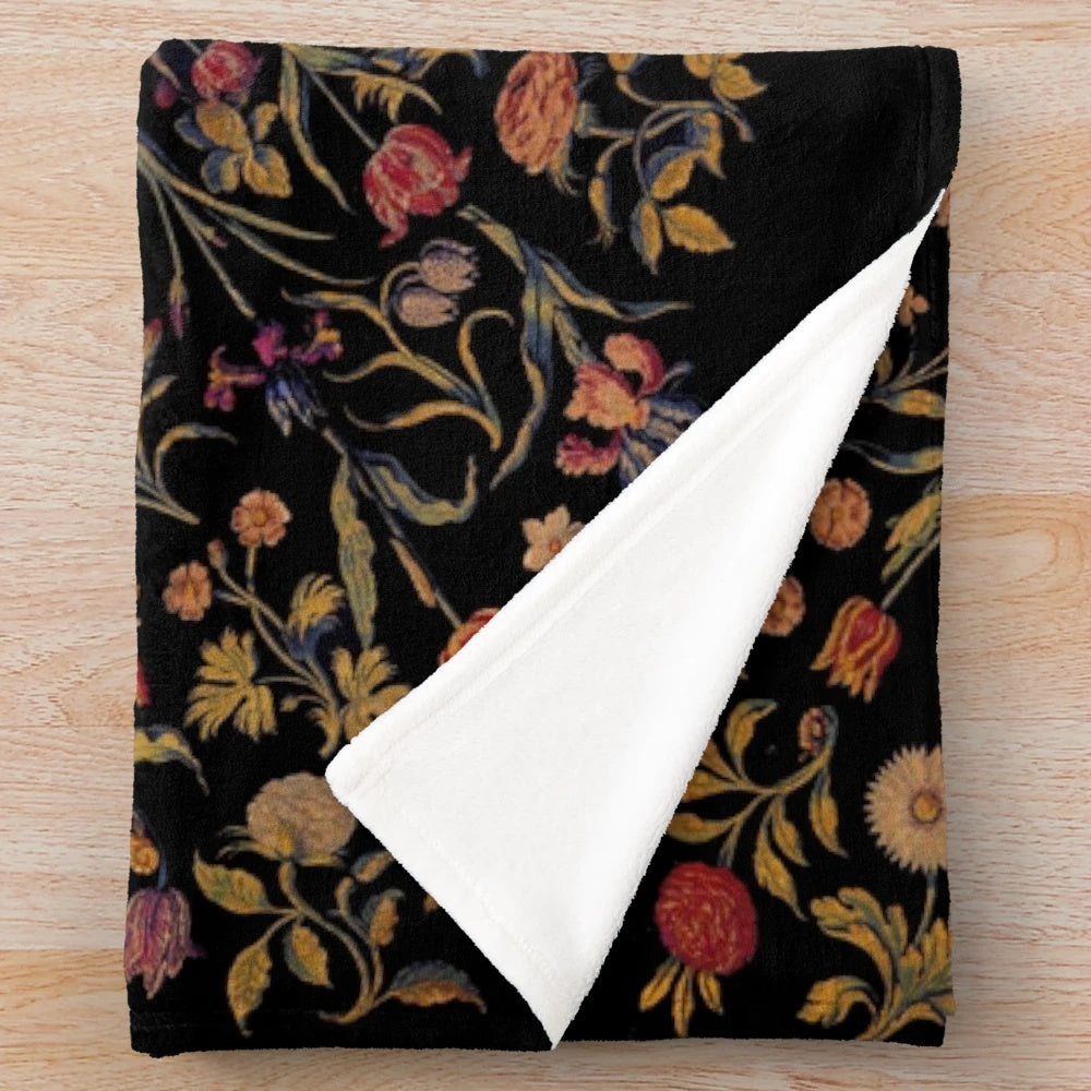 Medieval-inspired floral pattern on a soft, black plush blanket