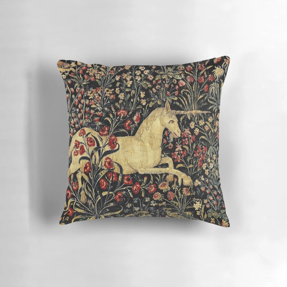 Decorative medieval-style pillow featuring a mythical unicorn surrounded by a lush black floral tapestry design.