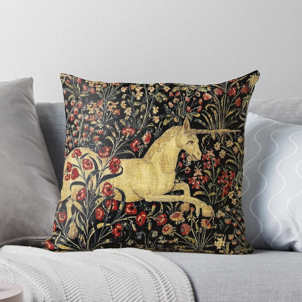 Decorative medieval-style pillow featuring a mythical unicorn surrounded by a lush black floral tapestry design.
