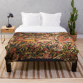 Plush blanket featuring a medieval-inspired design with mythical creatures like unicorns, dragons, and woodland animals surrounded by lush floral patterns.