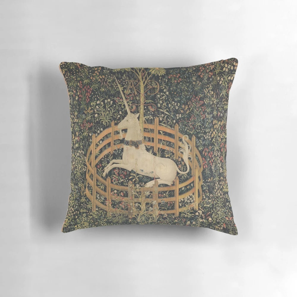 A medieval-inspired tapestry-style pillow featuring a mythical unicorn in a lush, floral setting.
