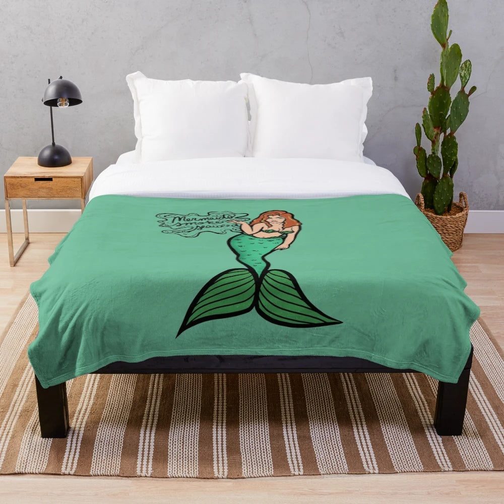 Plush blanket featuring a mermaid design with seaweed elements