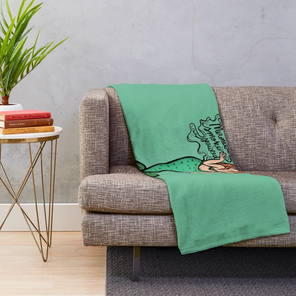 Plush blanket featuring a mermaid design with seaweed elements