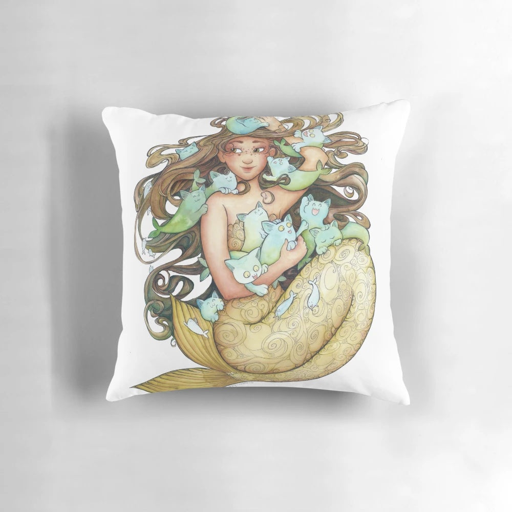 A decorative pillow featuring a playful design of mermaid-inspired kittens with freckles and whimsical details.