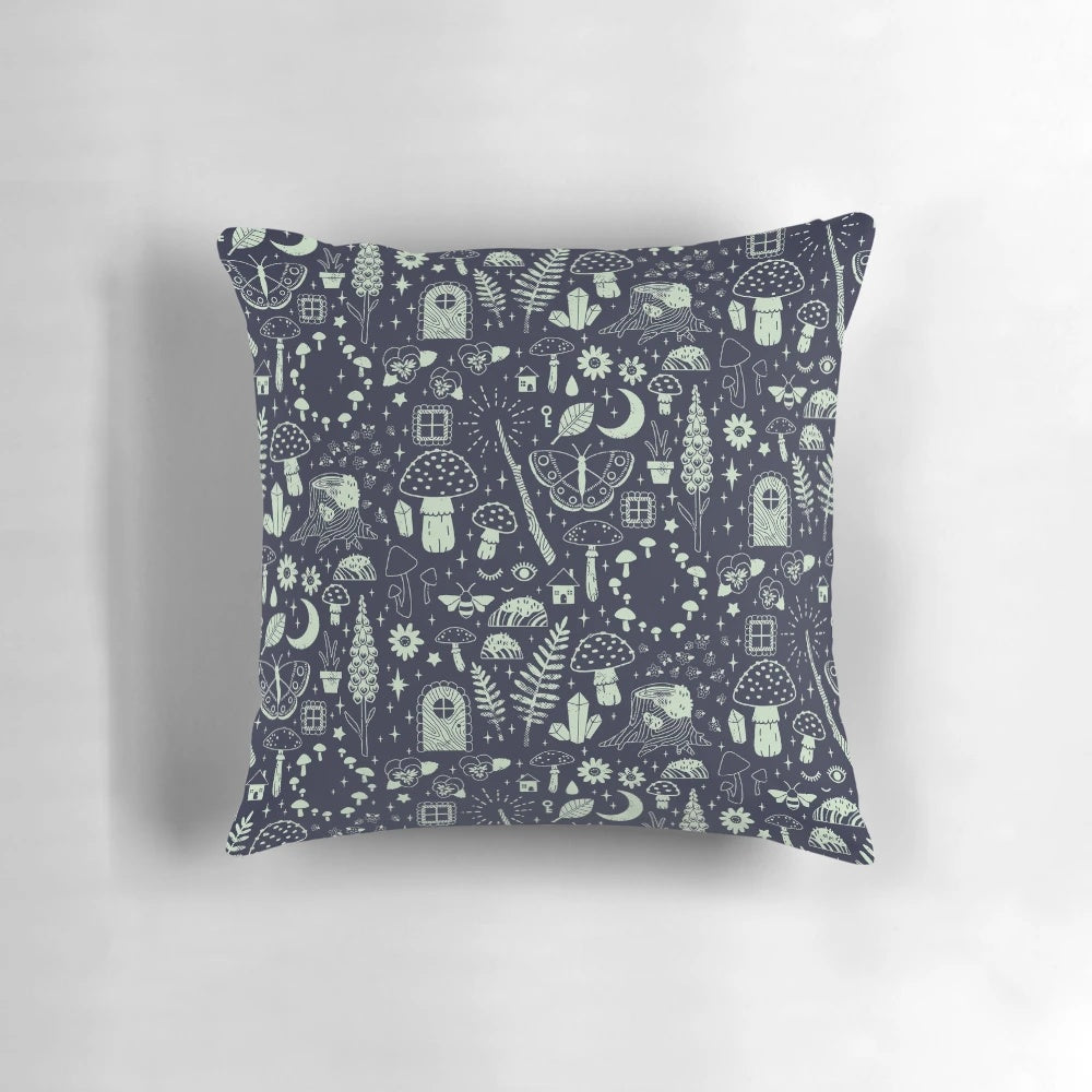 Whimsical fairy garden pillow with midnight design featuring mushrooms, butterflies, and flowers