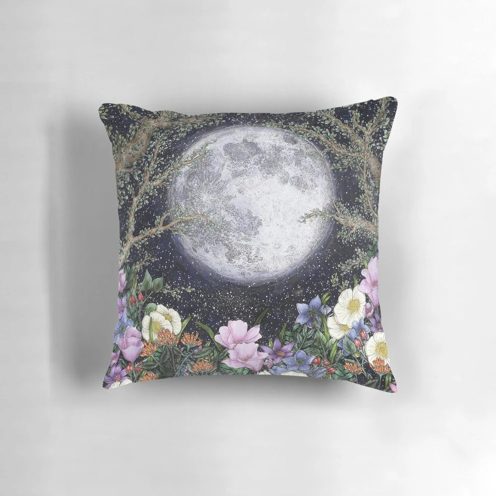 A beautiful pillow with a detailed illustration of a moonlit garden scene.