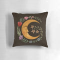 A decorative pillow featuring a beautiful moon and floral design, perfect for a cozy and serene bedroom.