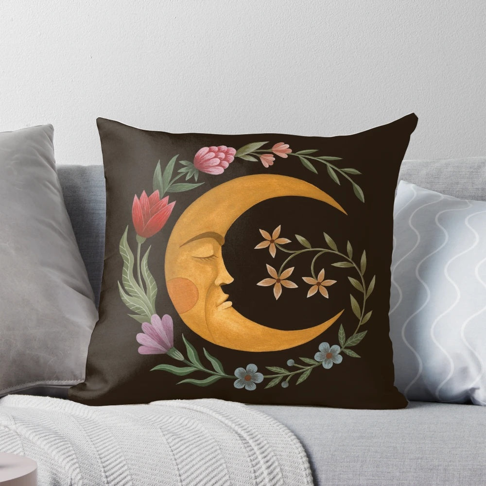 A decorative pillow featuring a beautiful moon and floral design, perfect for a cozy and serene bedroom.